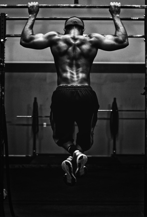 Man doing pull-ups on the horizontal bar